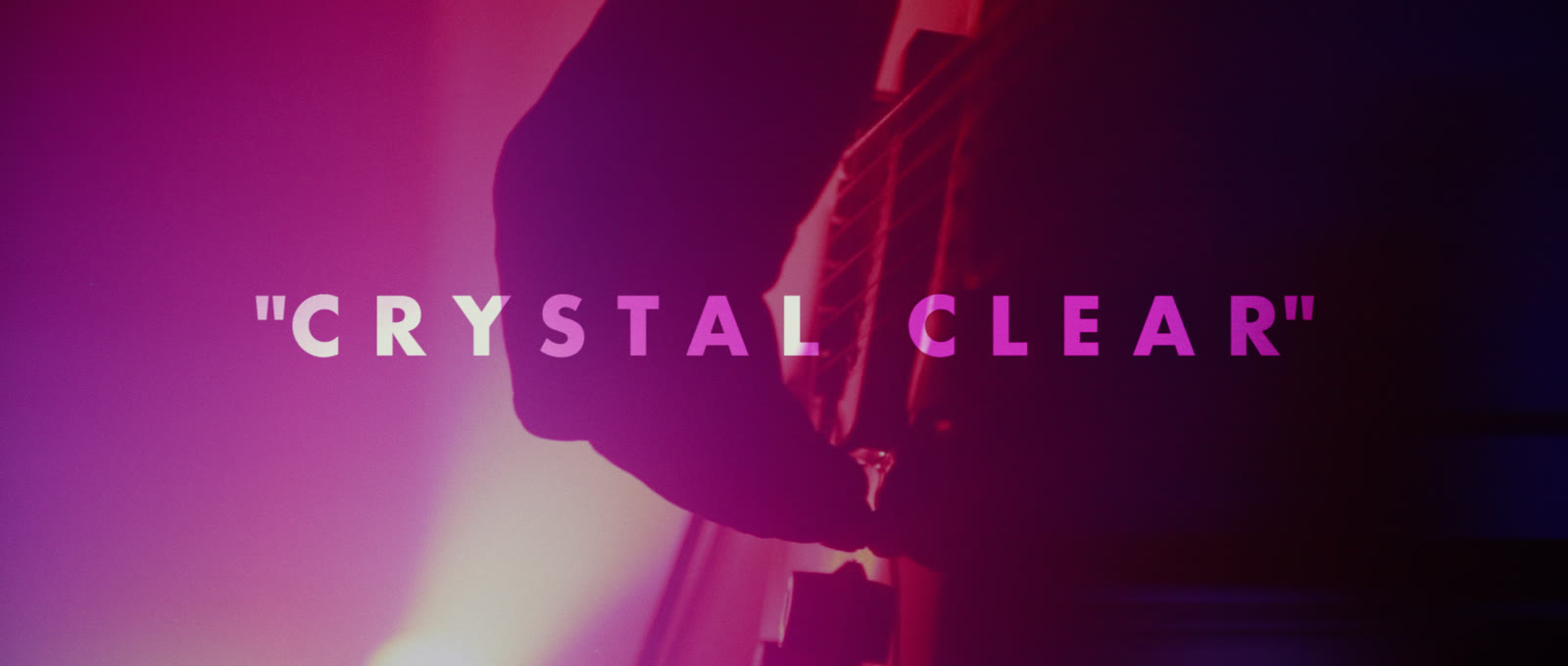 Embedded Crystal Clear title inside restrained red and blue haze.